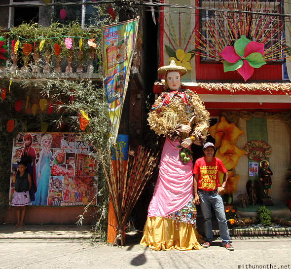 Tourists posing Pahiyas statue Philippines