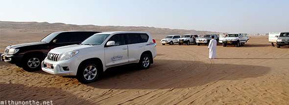 SUVs parked Oman desert