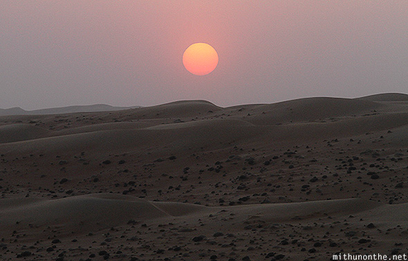 Sun setting Oman desert