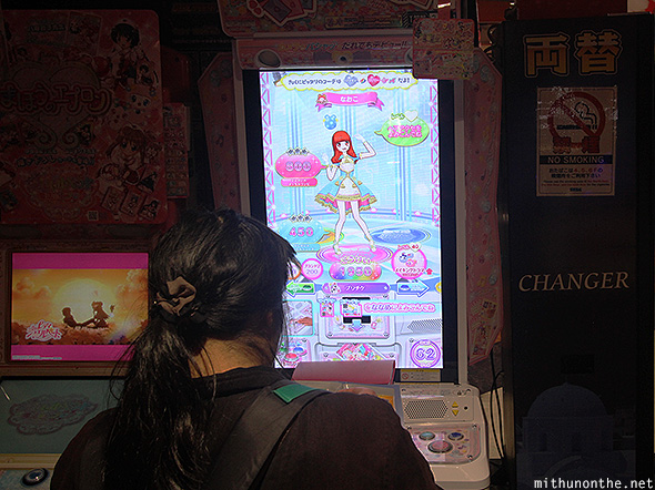 Girl playing dressup game Tokyo arcade