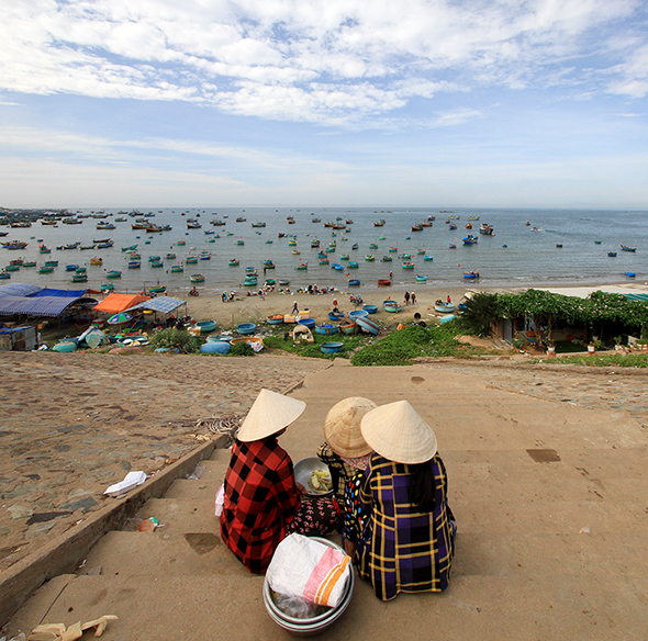 Ladies steps fishing beach Vietnam