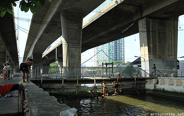 Under the bridge kids swimming Bangkok