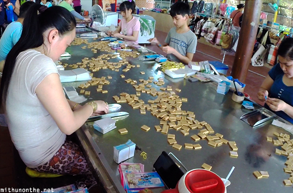 Wrapping coconut candy factory workers Vietnam