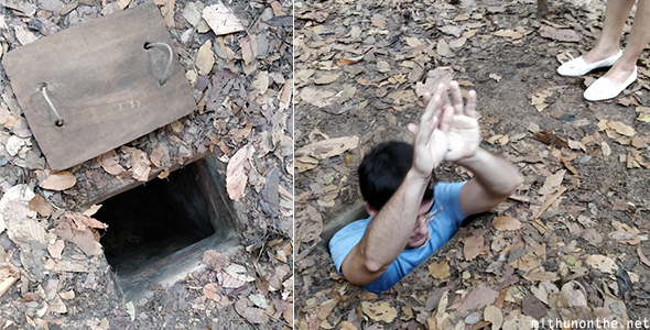 Going down narrow hole Cu Chi tunnels Vietnam