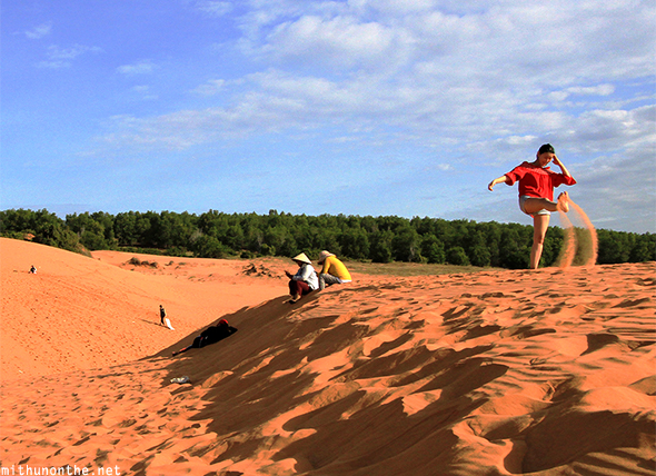 Girl kicking sand desert Vietnam